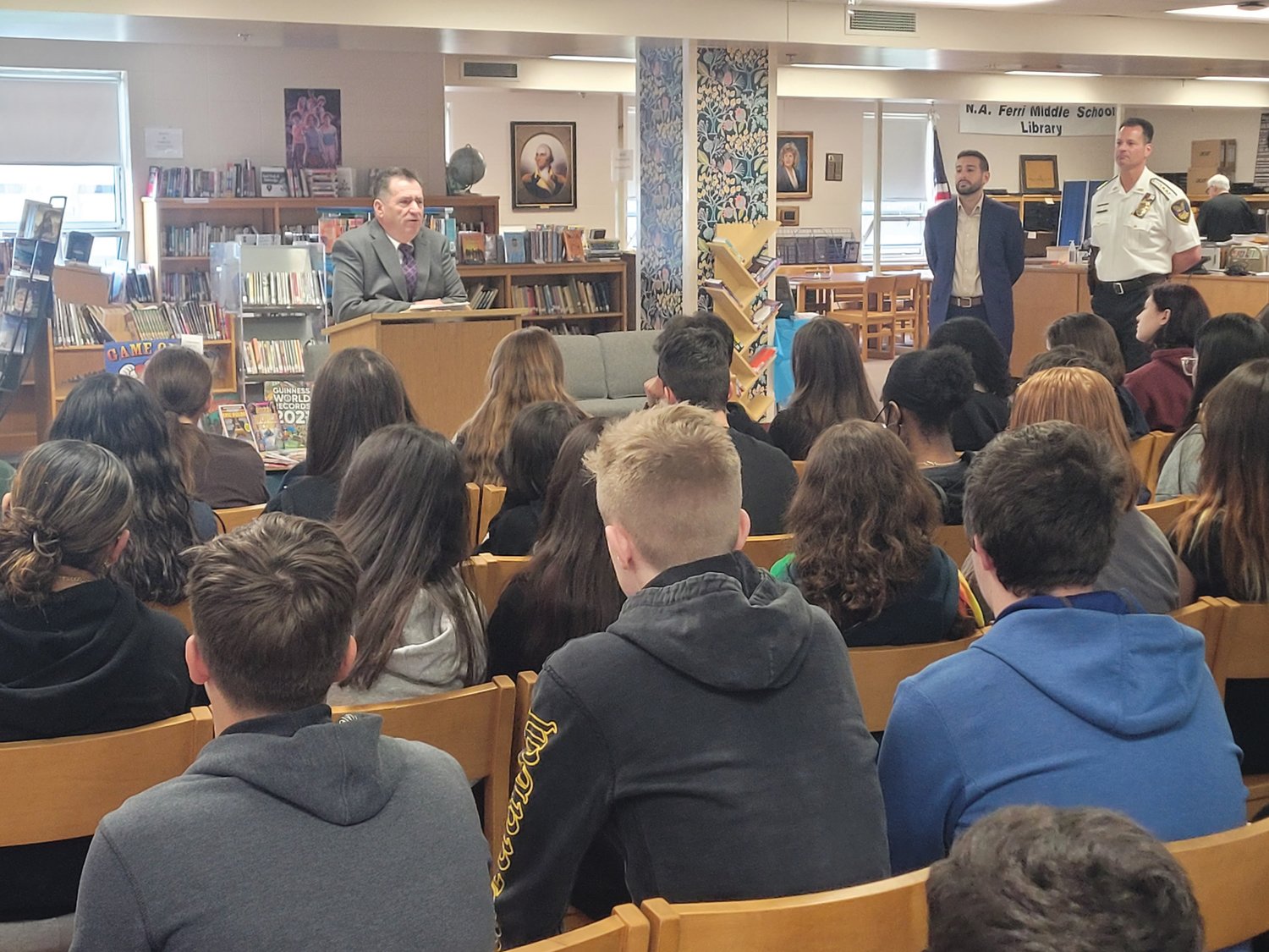 LAW DAY: Rhode Island Superior Court Associate Justice Joseph A. Montalbano, Johnston Town Council Vice President and mayoral candidate Joseph Polisena Jr., and Johnston Police Chief Joseph P. Razza stood in the Nicholas A. Ferri Middle School Library, facing a large group of civics students on Law Day last month. 